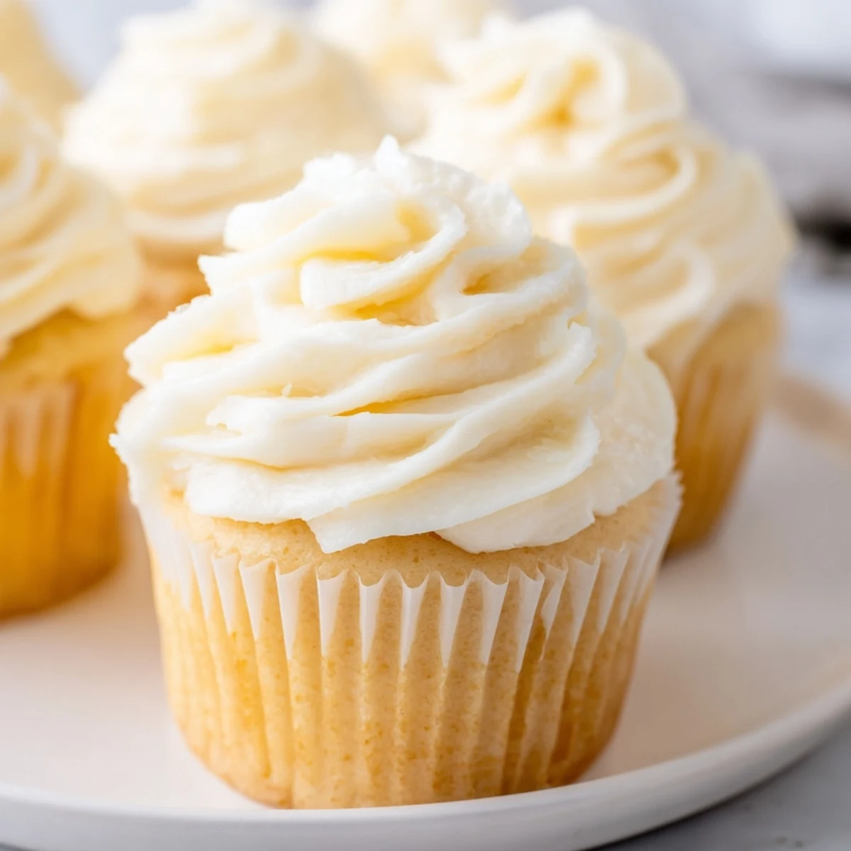 Fluffy vanilla cupcakes with creamy buttercream, a classic American dessert for celebrations.