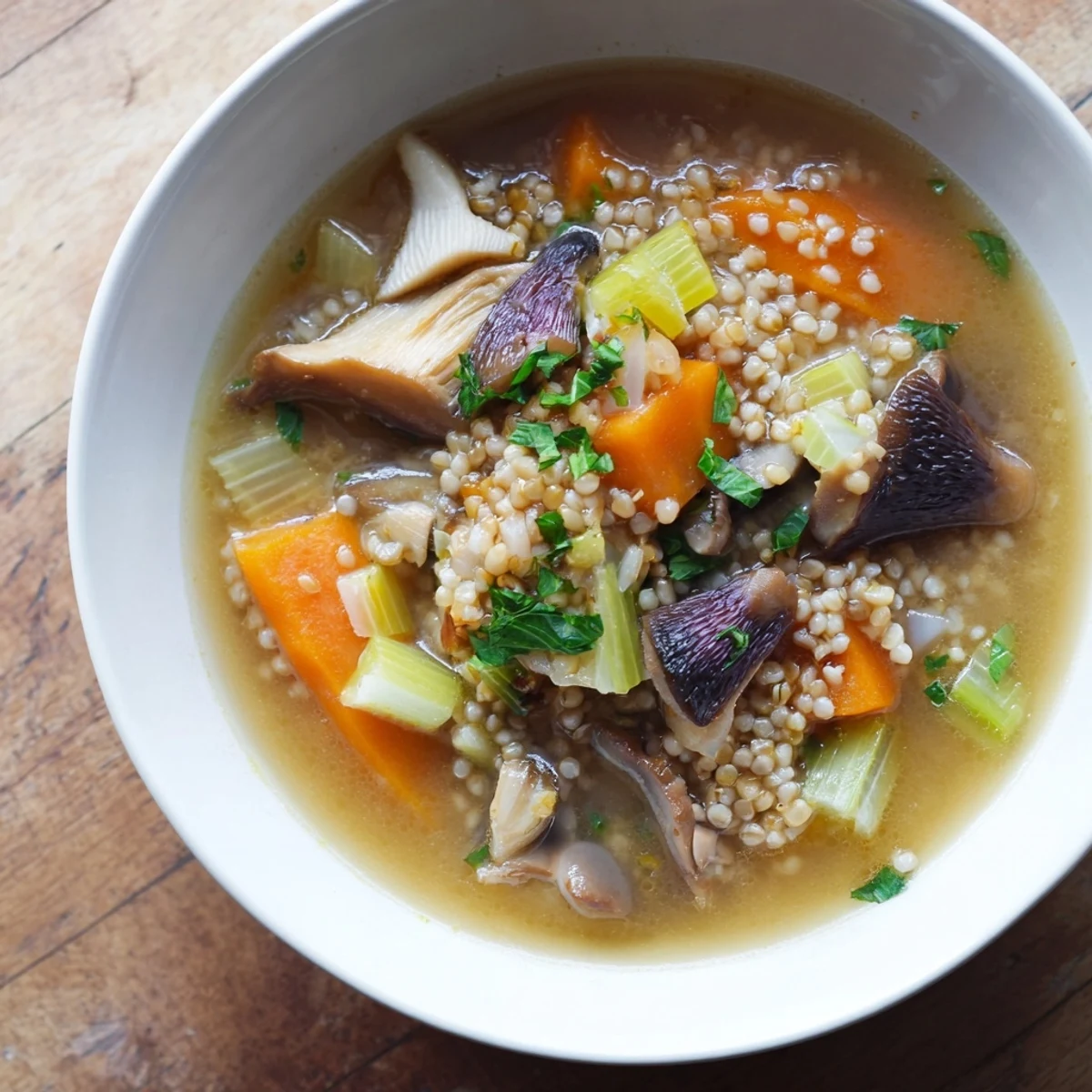 Steaming bowl of Wild Mushroom and Barley Soup, garnished with fresh parsley, ready to warm you.