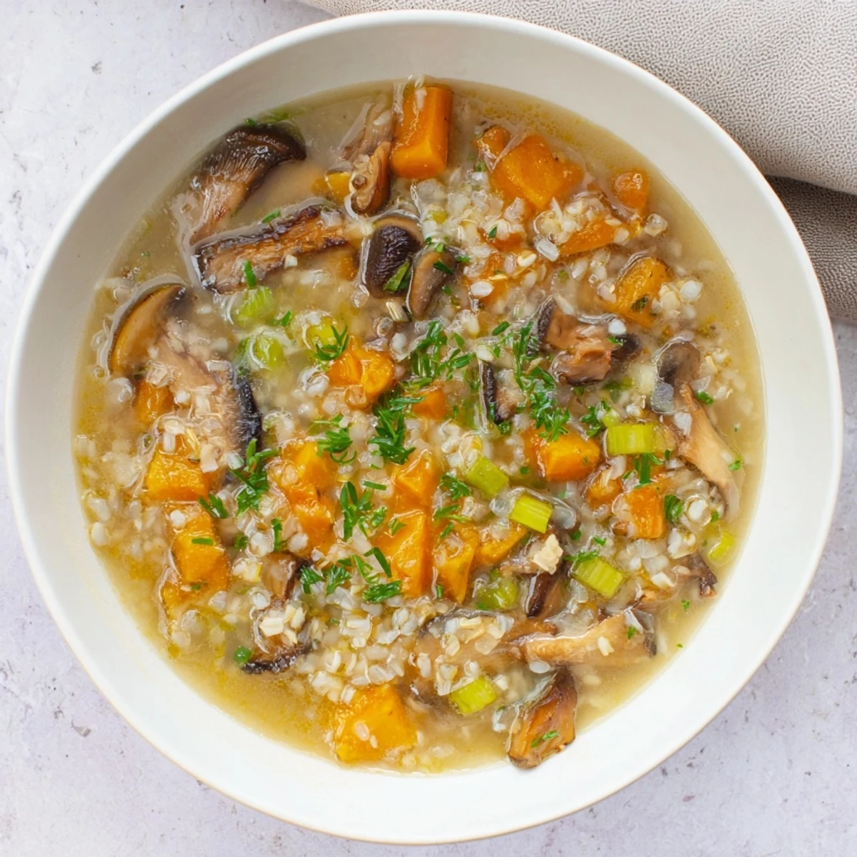 A close-up view of the hearty Wild Mushroom and Barley Soup, a comforting and rustic meal.