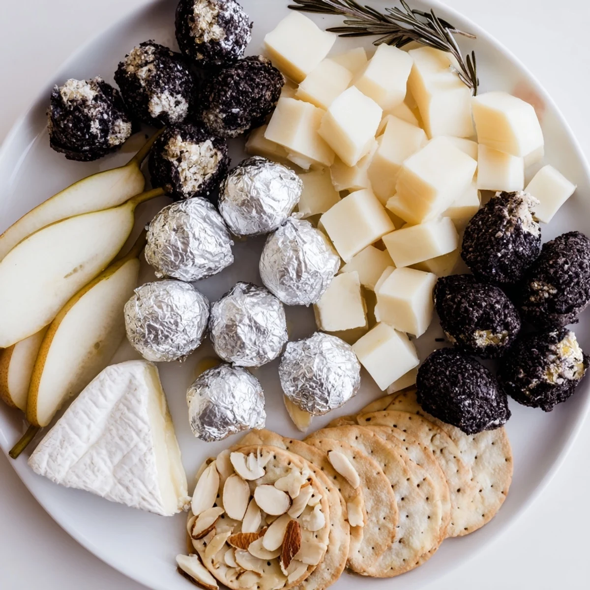 Artfully arranged The Silver Screen cheese board featuring creamy cheeses, dark chocolates, and ripe grapes.