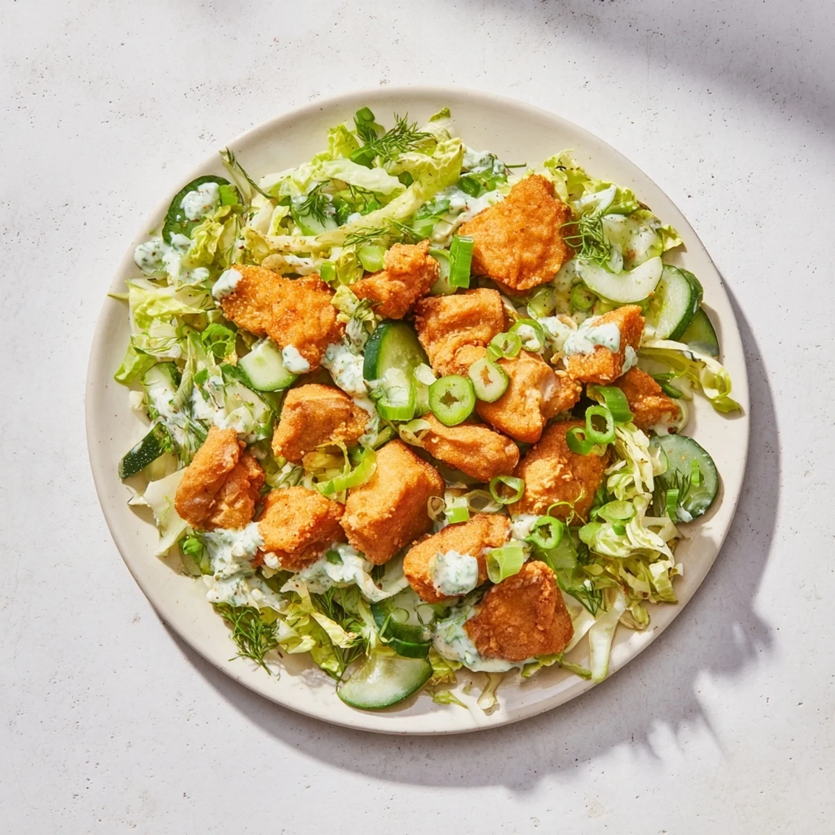 Fresh Green Goddess Nugget Salad: a close-up shows tender chicken nuggets with creamy green dressing.