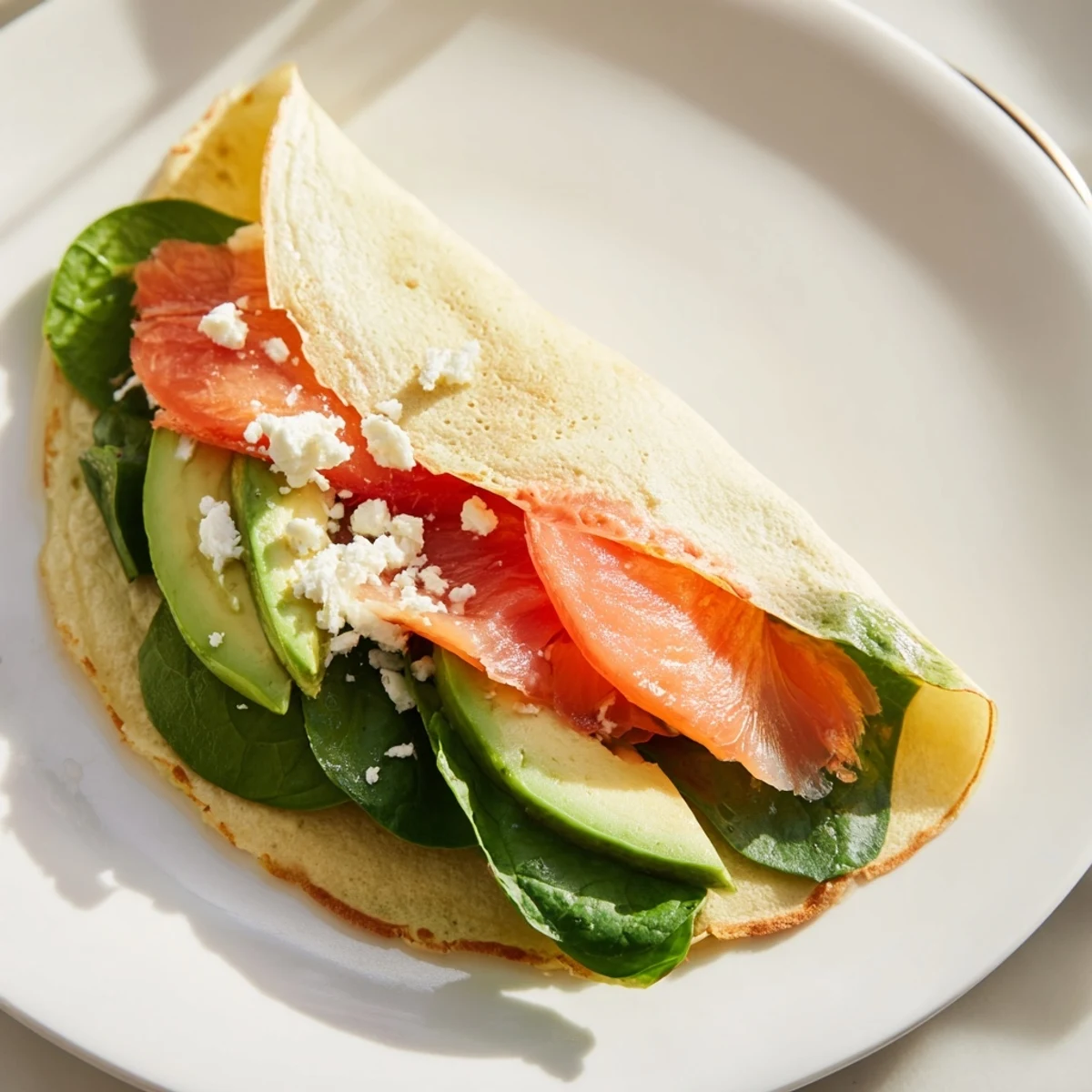 A beautifully wrapped Blender-Egg Crepe, showcasing delicate thinness with fresh, colorful tomato slices inside.