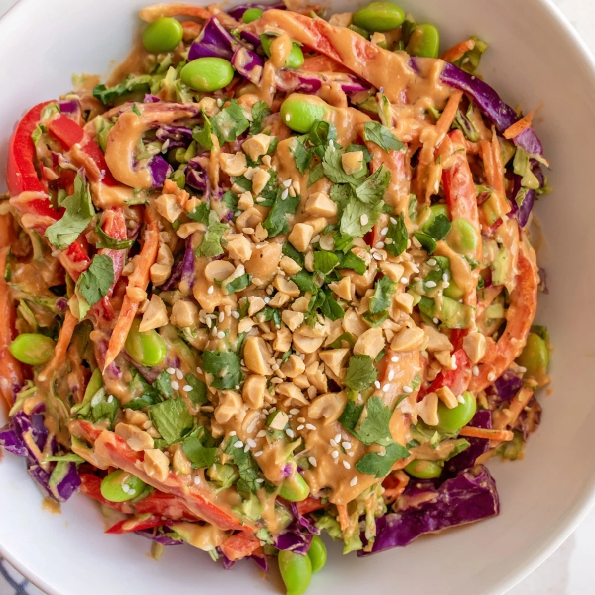 Fresh, colorful Crunchy Thai Peanut Salad with shredded cabbage, carrots, and edamame tossed in a creamy, tangy peanut dressing. 