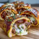 Golden-brown Irresistible High Protein Pepperoni Pizza Rolls arranged on a baking sheet, filled with savory ground beef and spicy pepperoni.