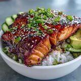 Quick 15-minute teriyaki salmon bowl with sweet soy glaze, fresh cucumber, carrot, and creamy avocado slices.