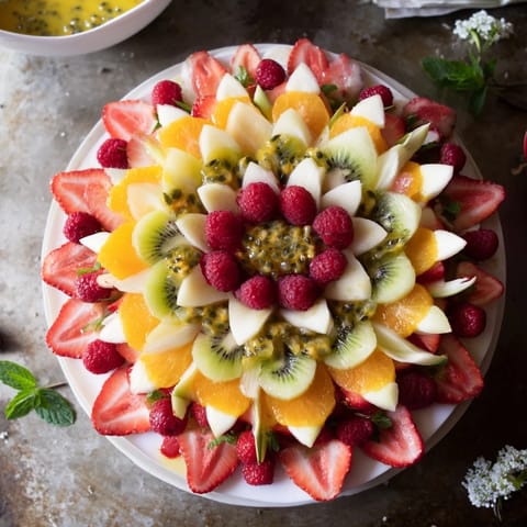 A stunning arrangement showcasing a Festive Poinsettia Fruit Bowl, perfect for holiday brunch parties with fresh fruit.