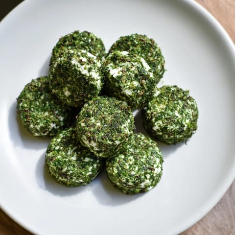 Fresh parsley and dill coat goat cheese for these earthy, vegetarian Mossy Stones, ready to serve.