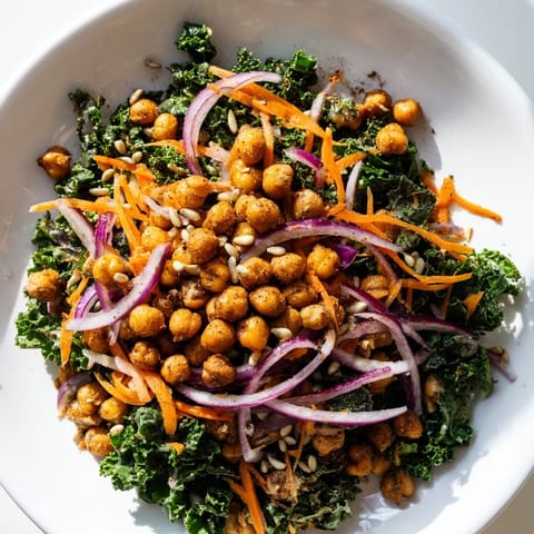 Brightly colored kale salad with roasted chickpeas, featuring crunchy chickpeas and a zesty dressing.