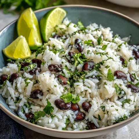 Fragrant steamed Coconut Lime Rice, fluffy grains studded with beans and cilantro.