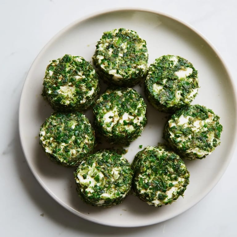 A cheese platter showcases charming, herb-covered Mossy Stones, an easy appetizer perfect for guests.
