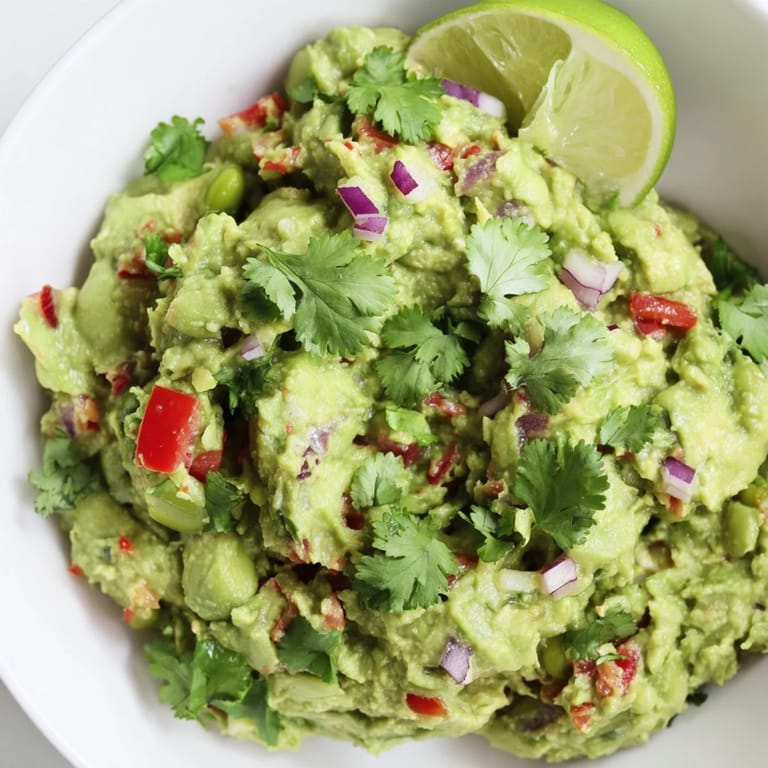 Freshly made Edamame Guacamole, ideal for dipping, showcases its texture and colorful presentation.