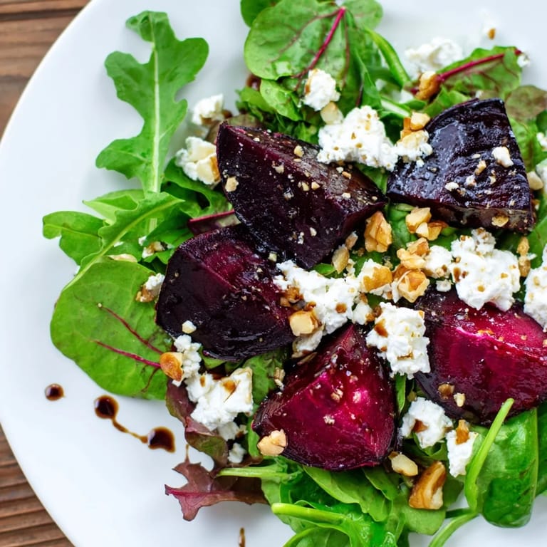 Colorful beet and goat cheese salad, drizzled with tangy balsamic vinaigrette for a fresh bite.
