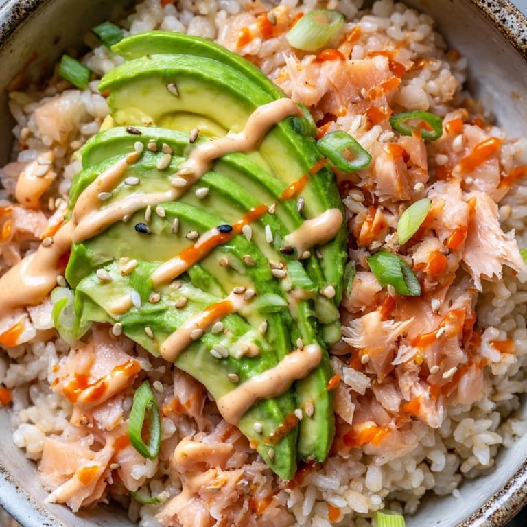 Serving suggestion for Emily Mariko Salmon Rice Bowl with nori sheets, avocado, and spicy mayo.