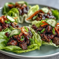 Korean BBQ beef lettuce wraps, vibrant with kimchi, ready to be assembled.